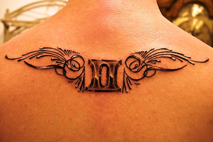 zodiac gemini tattoo on upper back