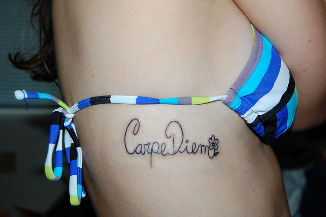 small carpe diem tattoo on rib